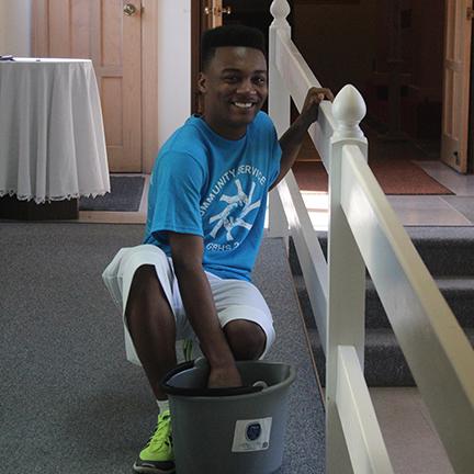 Eddie Beach (Jr) cleaning a handrail on Community Service Day 2015.