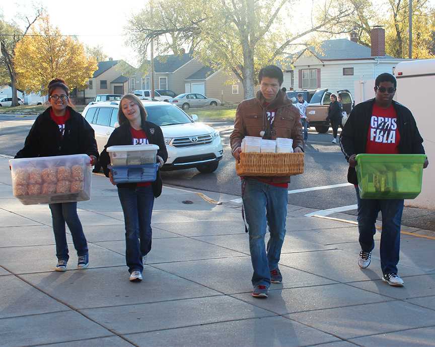 FBLA members, Melina Chavez, Audrey Muth, Marcos Martinez and Ozioma Ofoma assist vendors carry in their items for the festival.