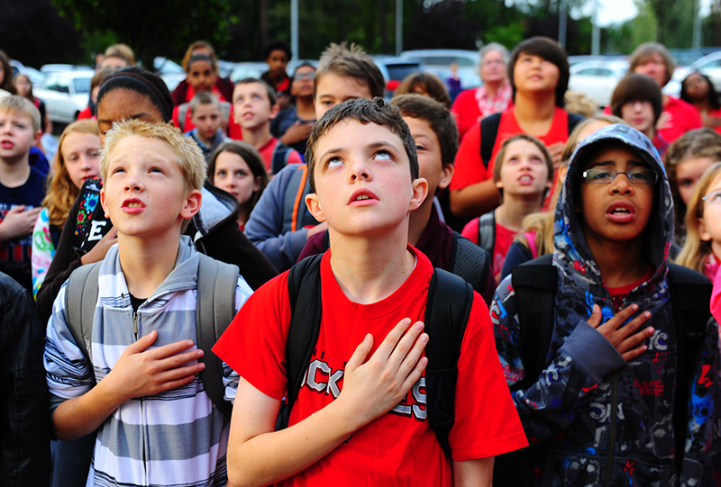 Students from Ramstein Middle School resite the Pledge of Allegiance during a commemoration ceremony, Ramstein Air Base, Germany, Sep. 9, 2011. This year marks the 10th anniversary of the Sep. 11th attacks. (U.S. Air Force photo by Airman 1st Class Brea Miller)