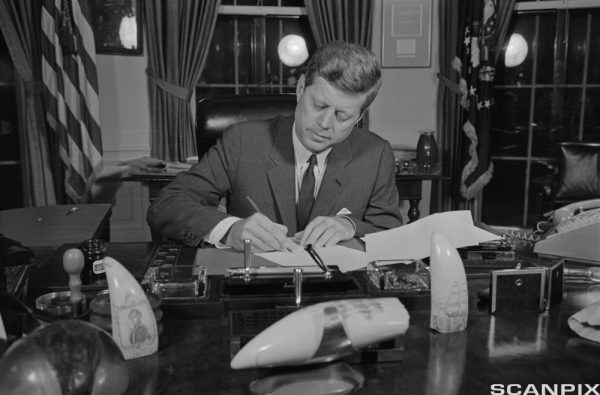 ca. 1962, Washington, DC, USA --- Original caption: President Kennedy tonight signs a proclamation formally putting into effect at 10 A.M. EDT tomorrow the U.S. Arms Quarantine against Cuba.  The President signed the proclamation without comment in his office. --- Image by © Bettmann/CORBIS